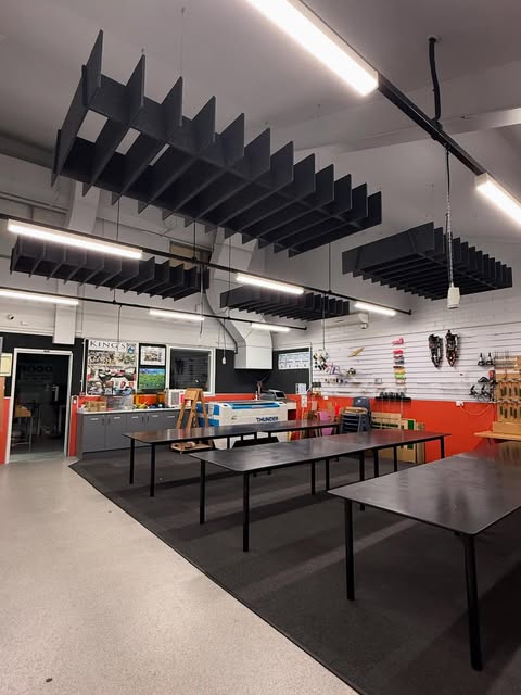 Black suspended acoustic ceiling panels in a commercial interior
